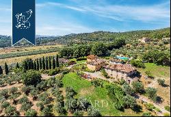 Luxury country house for sale with a forest, olive grove and pool on the Tuscan hills