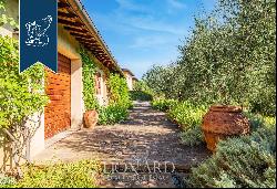 Luxury country house for sale with a forest, olive grove and pool on the Tuscan hills