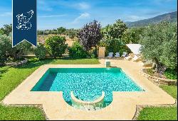 Elegant villa with an outbuilding and big private garden for sale on the Tuscan coast