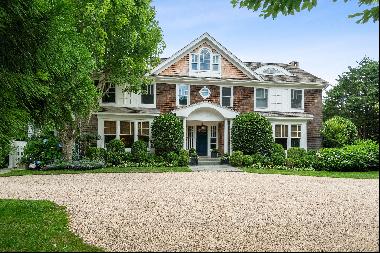 This impeccable, eight-bedroom, six and one half-bath home has a gourmet kitchen, formal d