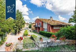 Villa with swimming pool and a tennis court surrounded by a hunting reserve