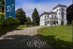 Panoramic estate surrounded by a big, leafy park with a charming view of the lake