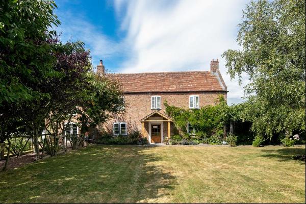 A pretty and well-presented 5 bedroom period farmhouse with about 2.27 acre, 3 holiday let
