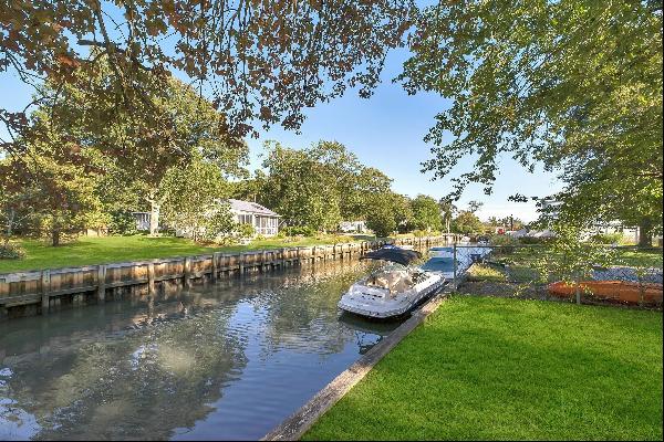 Located on a canal, this home offers 3 bedrooms, 2 baths, primary en suite has two walk-in