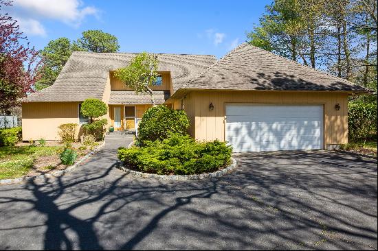 Bright and beachy home with two-story vaulted ceiling in great room, four bedrooms, and th