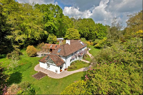 An unlisted, period cottage set in about 4 acres of beautiful, broadleaf woodland with a s