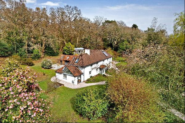An unlisted, period cottage set in about 4 acres of beautiful, broadleaf woodland with a s