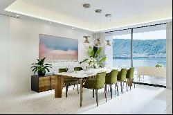 For sale in Lugano-Bissone elegant apartment with terrace & magic lake view