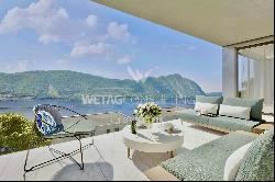 For sale in Lugano-Bissone elegant apartment with terrace & magic lake view