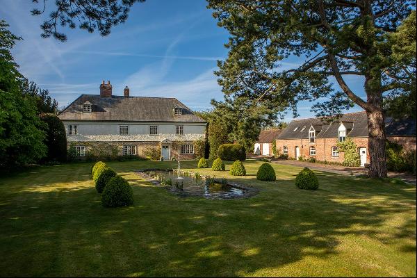 An attractive Grade II listed period farm house offering excellent accommodation together 