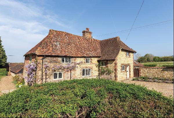 A wonderful Grade II listed farmhouse with superb secondary accommodation, stabling, and n