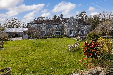 A medieval manor house set within a secluded wooded valley with two cottages, historic bar