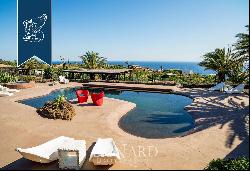 Eight typical buildings made of lava stone with pools inside a private area with gardens