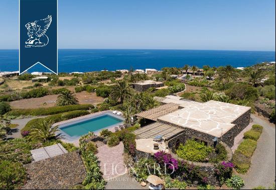 Eight typical buildings made of lava stone with pools inside a private area with gardens