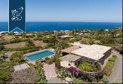 Eight typical buildings made of lava stone with pools inside a private area with gardens