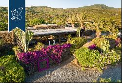 Eight typical buildings made of lava stone with pools inside a private area with gardens