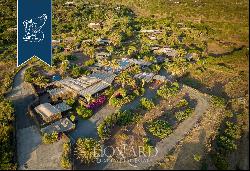 Eight typical buildings made of lava stone with pools inside a private area with gardens