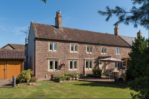 An attractive, spacious and well presented Grade II listed former farmhouse with private s