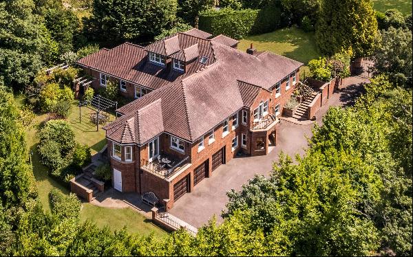 A substantial and elegant 6 bed detached house with landscaped gardens and far reaching vi