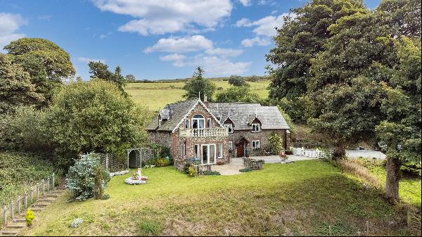A detached four-bedroom house with far-reaching westerly views, set in 9.3 acres with stab