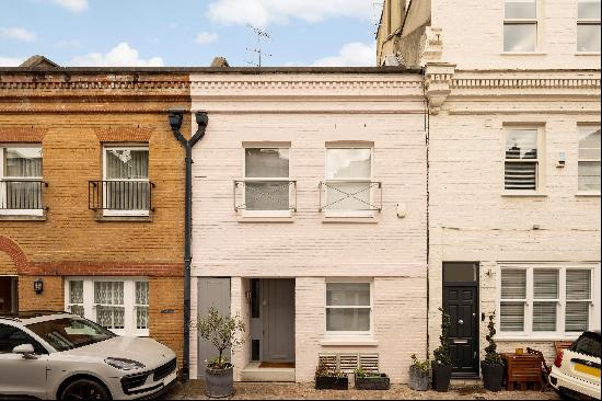 An impressive three/four bedroom mews house with a double garage and a walled garden for s