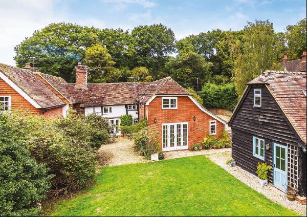 A wonderful, attached Grade II listed period cottage with excellent outbuildings and 2.37 