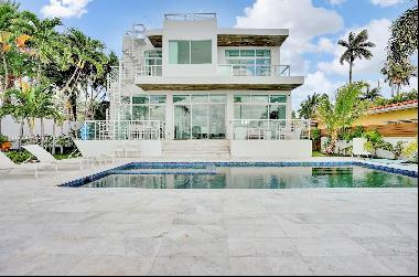This luxurious North Bay Village waterfront property is located in a gated community and i