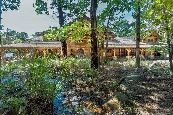 Situated in Water Mill and surrounded by over 60 acres of unspoiled nature, this private t