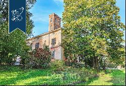 Between Italy and Switzerland: historical estate for sale with a villa, a tower, an outbui