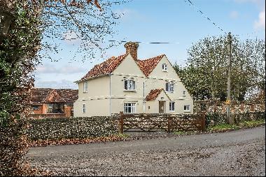 A Grade II listed farmhouse with 17th century origins in need of renovation sitting in abo