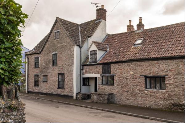 A stunning mid 17th century village home with a detached annexe, heated swimming pool, gar