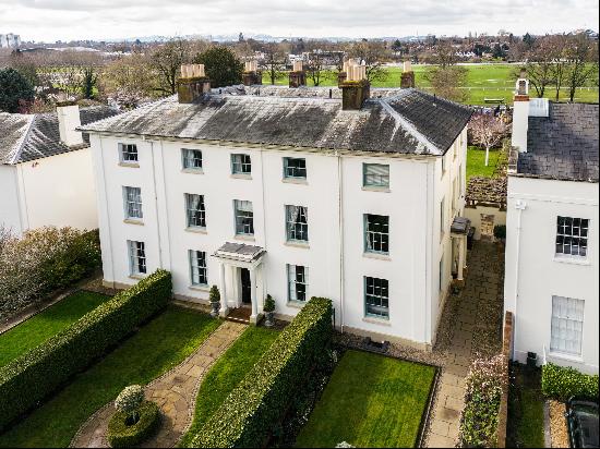 A handsome Grade II Listed, end-terrace house with a west facing garden on a desirable squ