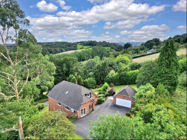 A stylishly appointed detached house with stunning elevated views, in the peaceful village