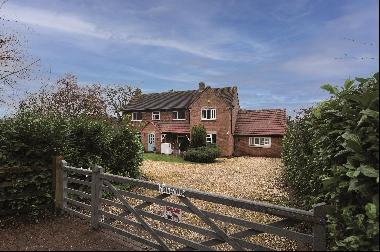 An attractive and spacious family home with paddocks and stables in a highly sought-after 