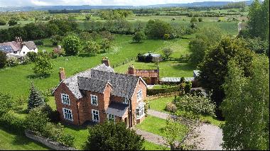 Set in a plot of 1.3 acres, a versatile five bedroom period home with outbuildings that in