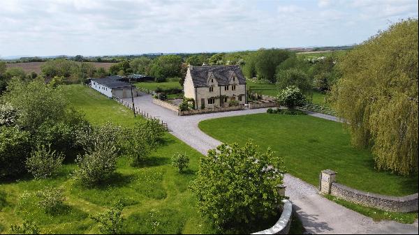 A handsome and beautifully presented Grade II listed farmhouse accompanied by a range of v