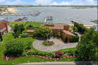 Welcome to this extraordinary waterfront contemporary located in picturesque Hewlett Harbo