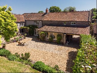 A very attractive period village house with a large south west facing garden adjoining far