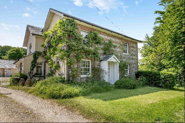 An attractive 19th century house and guest cottage set in about 1.25 acres within an AONB.