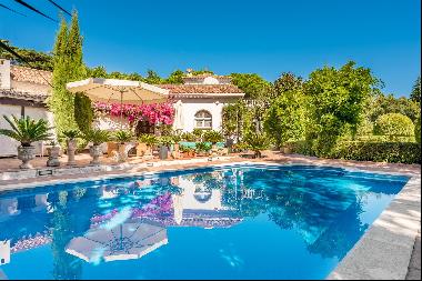 Andalusian-style villa with a swimming pool and lush gardens