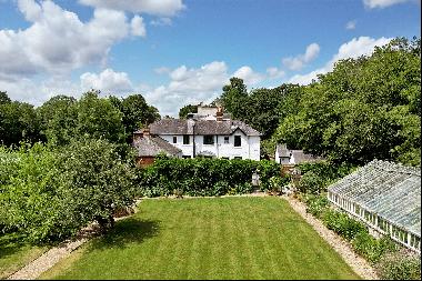 A charming Victorian family home with a very special 100-year-old walled garden. Adjoining