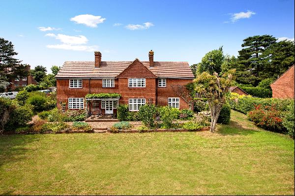 A substantial detached family home with six bedrooms and a delightful garden, in a highly 