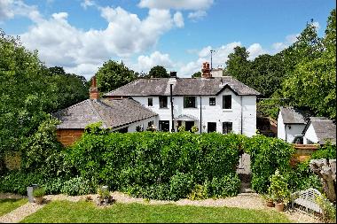 A charming Victorian Coach House with a very special 100-year-old walled garden.  An adjoi