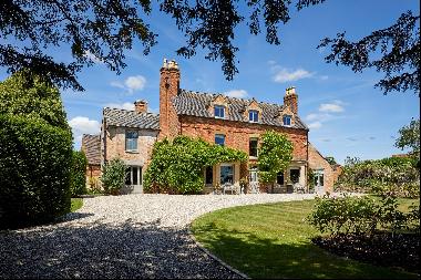 A fine Grade II listed manor house and cottage with attractive mature gardens and grounds 