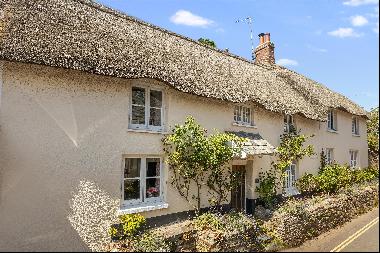 A gorgeous Grade II listed cottage in the heart of this prime coastal village, with large 