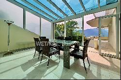 Elegant triplex-apartment for sale in Porza, with lake view, private garden, swimming poo