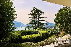 Elegant triplex-apartment for sale in Porza, with lake view, private garden, swimming poo