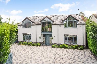 An immaculately presented contemporary family home set back from the road behind gates clo