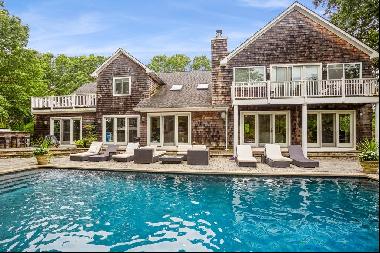 Set on two bucolic acres in Quogue adjoining a 6.5 acre reserve, this luxurious resort-lik