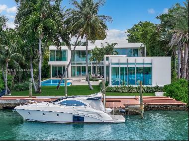 In a league of its own, this modern estate redefines luxury living on guard gated Palm Isl